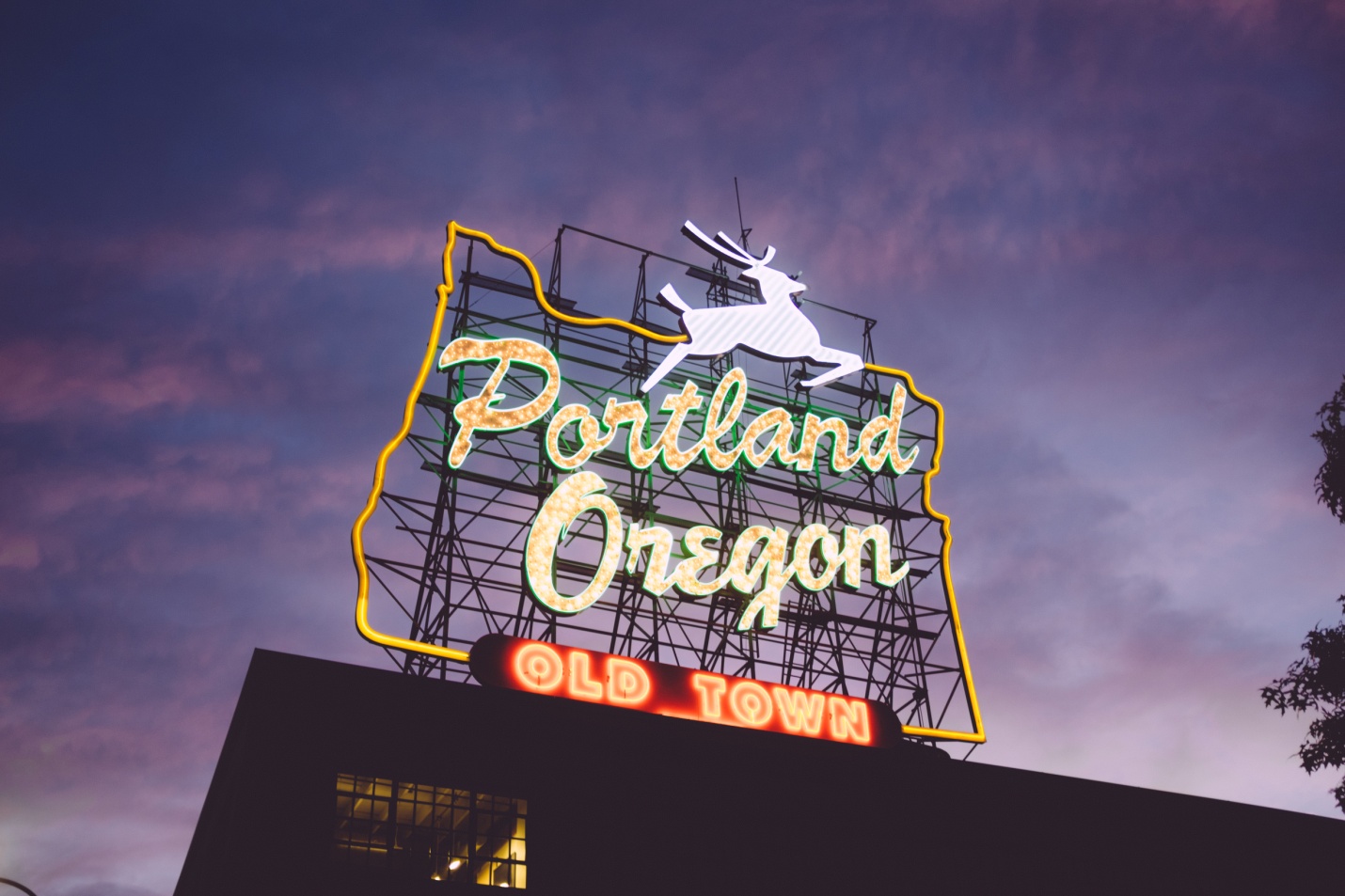 A neon sign that reads Portland, Oregon; a city with weird things