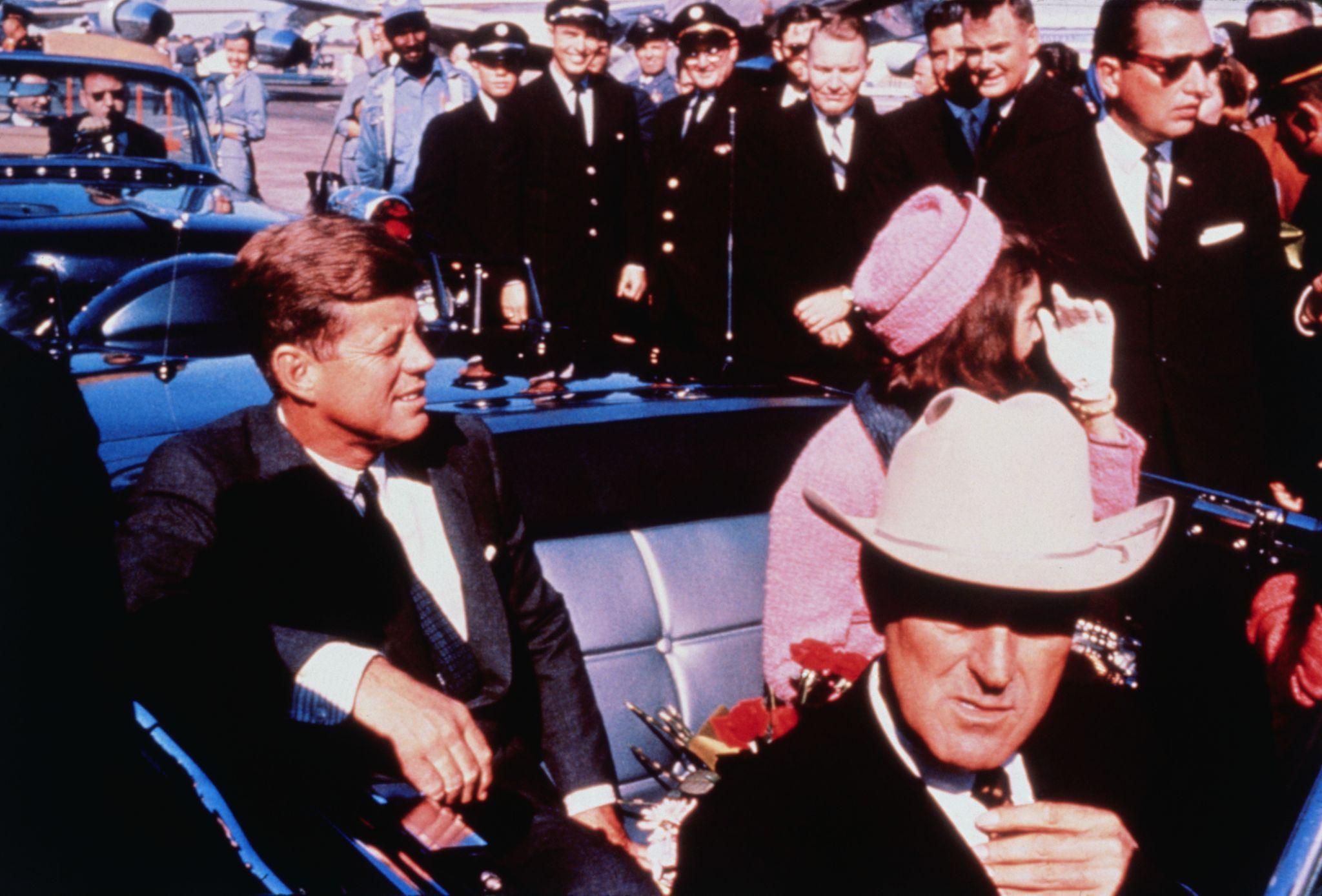 President John F. Kennedy, Jackie Kennedy, and Governor John Connally ride in a limousine on November 22, 1963
