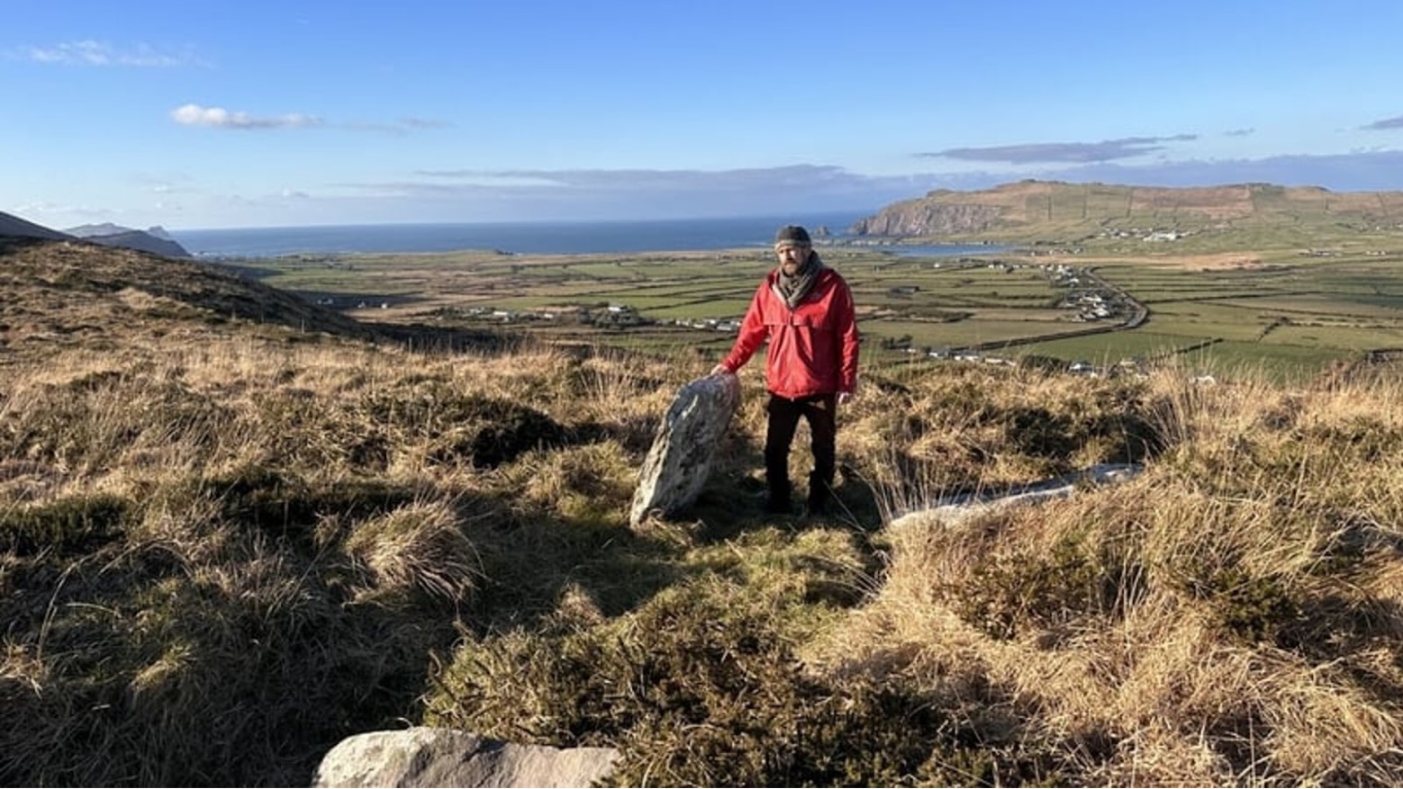 Bill Mag Fhloinn with his hand on one of the rocks of Altóir na Gréine