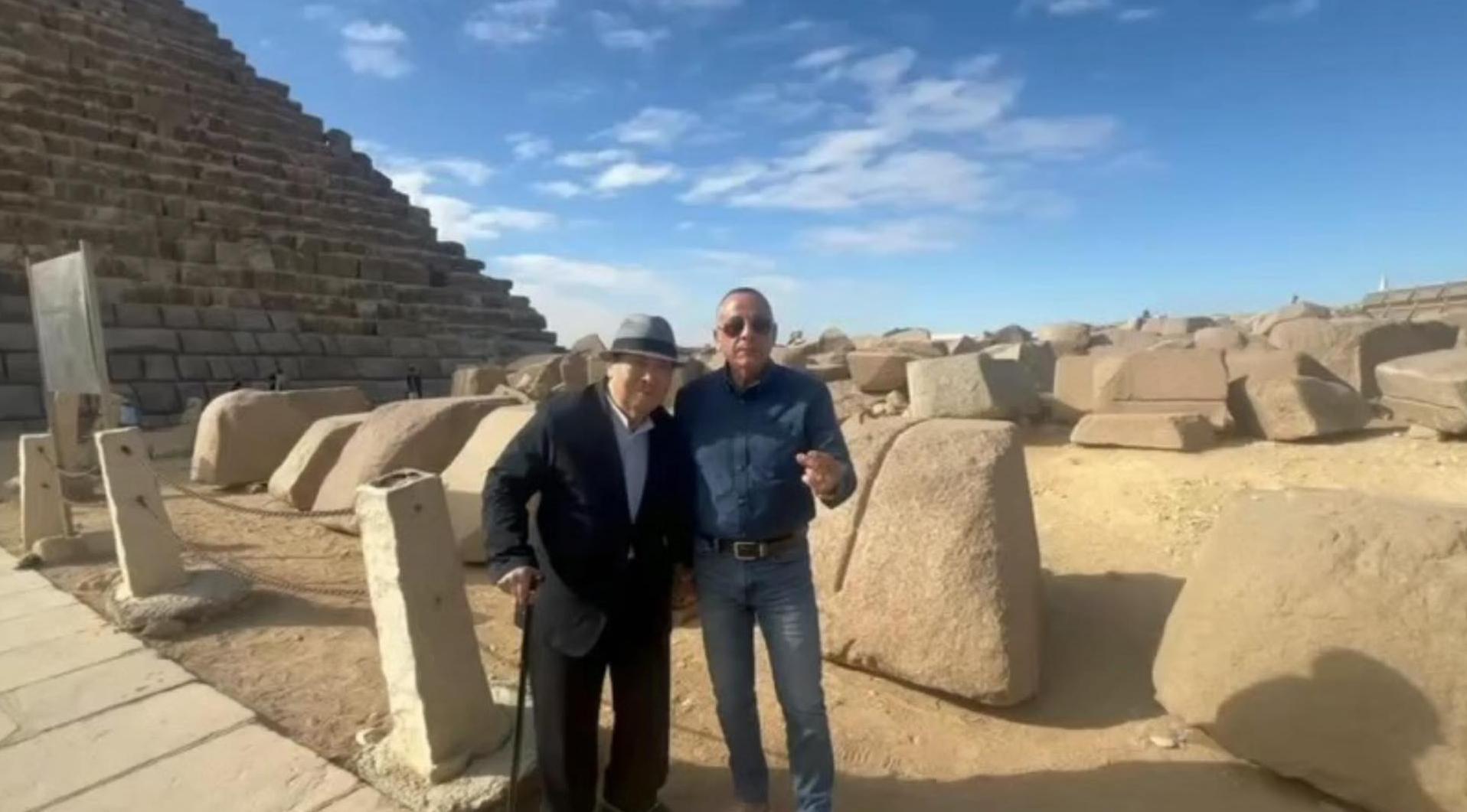 Waziry poses for a photograph alongside a friend close to the pyramid of Menkaure