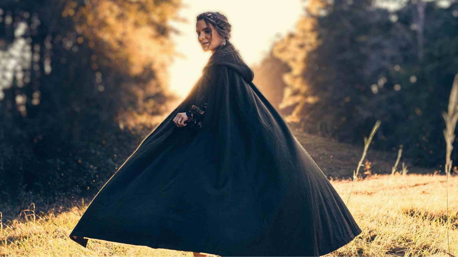 A woman wearing a cloak.