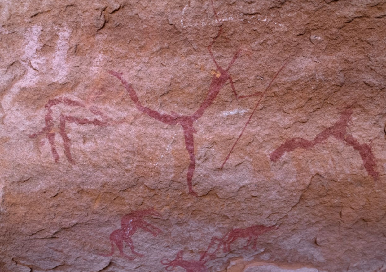 Rock painting depicting men hunting with dogs, Tassili N'Ajjer National Park, Tadrart Rouge, Algeria