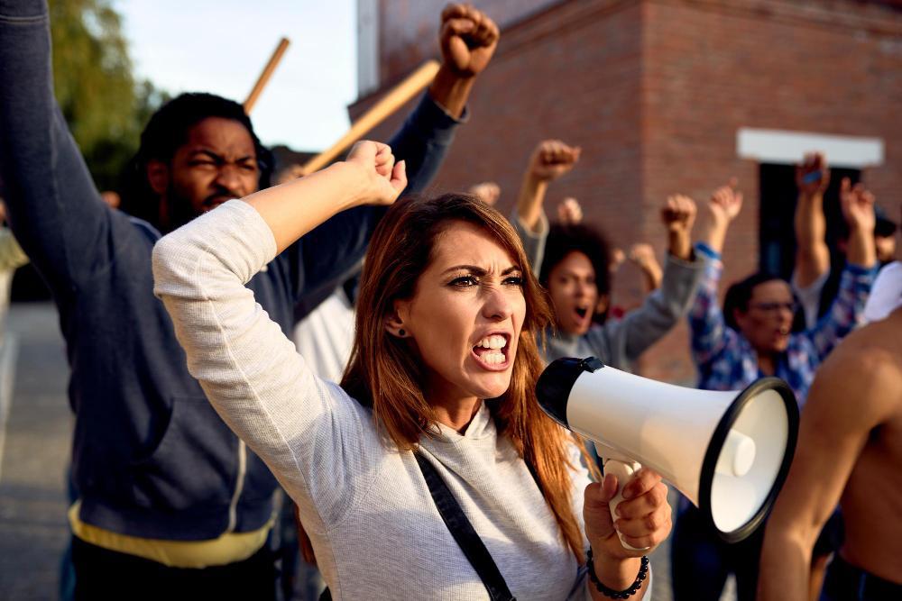 A woman is pictured alongside a group of protesters on the street