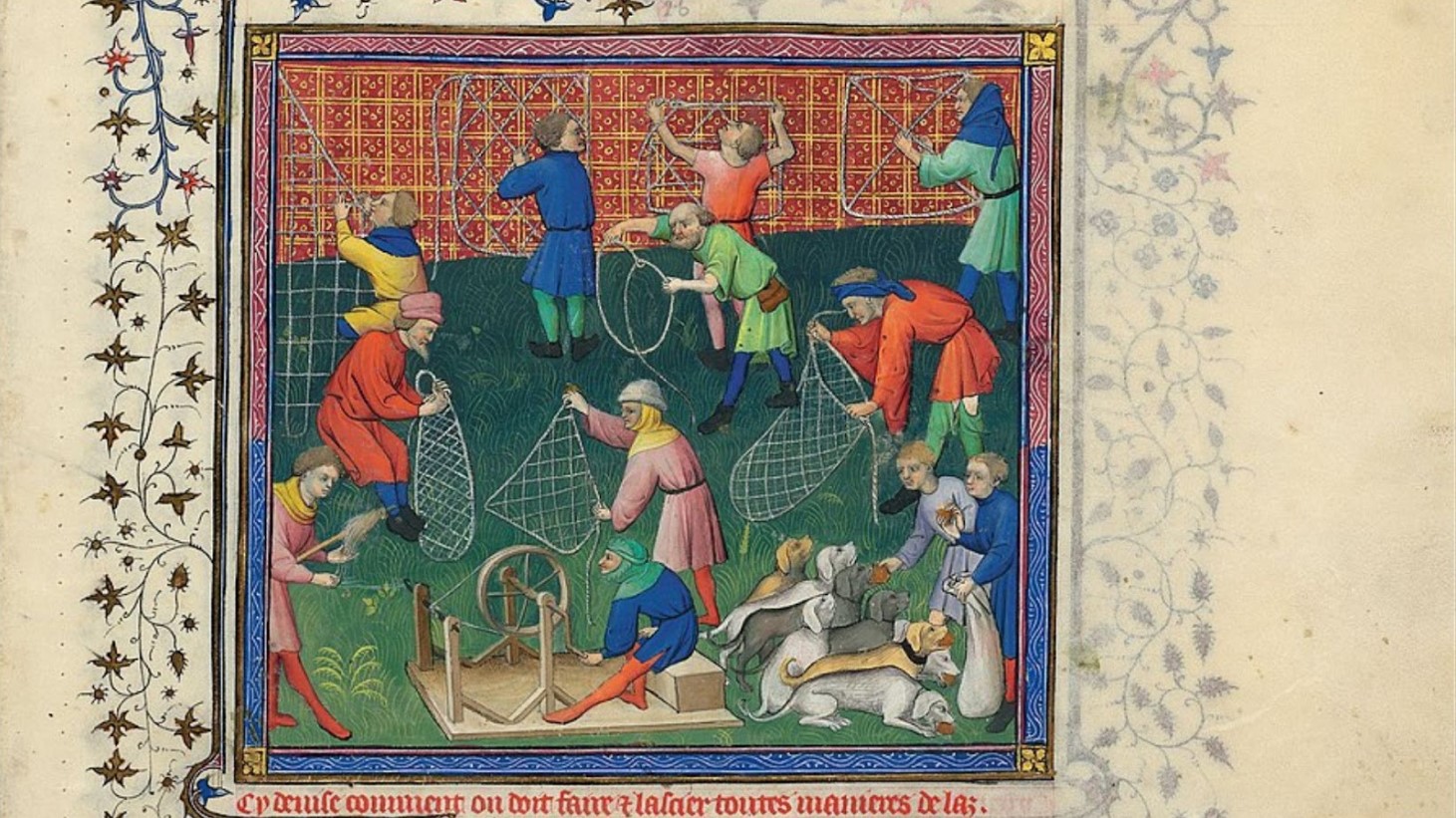 An illustration of several figures, clad in brightly colored clothing, are depicted in various stages of a hunt. Some are handling large nets, while others are blowing horns. On the ground, multiple dogs are shown in different states of activity, with some attacking a fallen stag