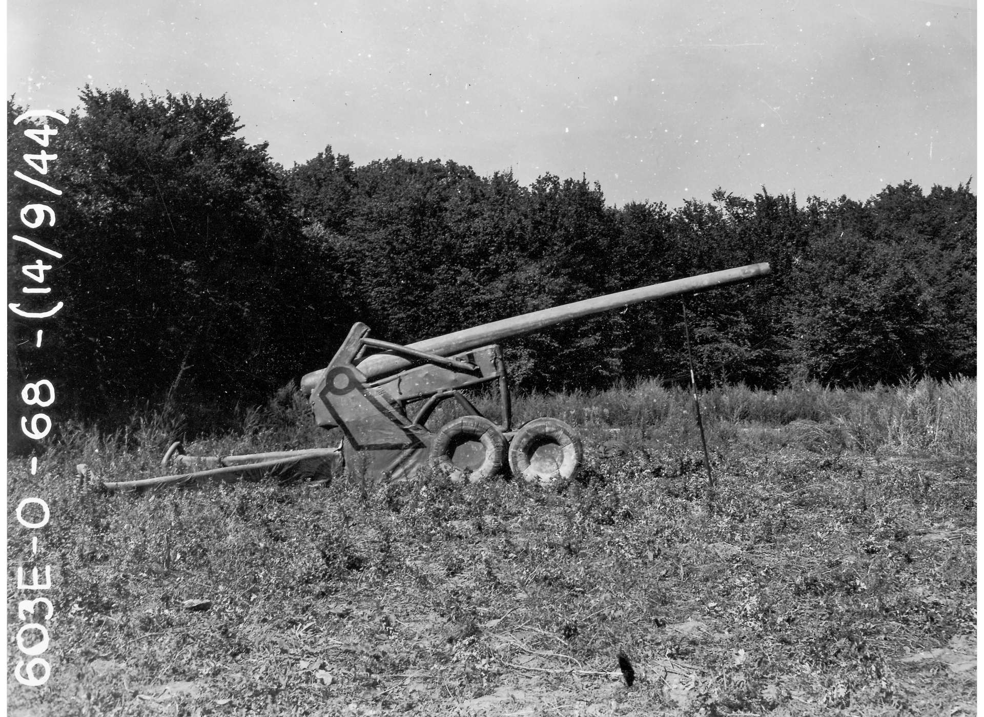 A gray scale image of faux artillery in a field