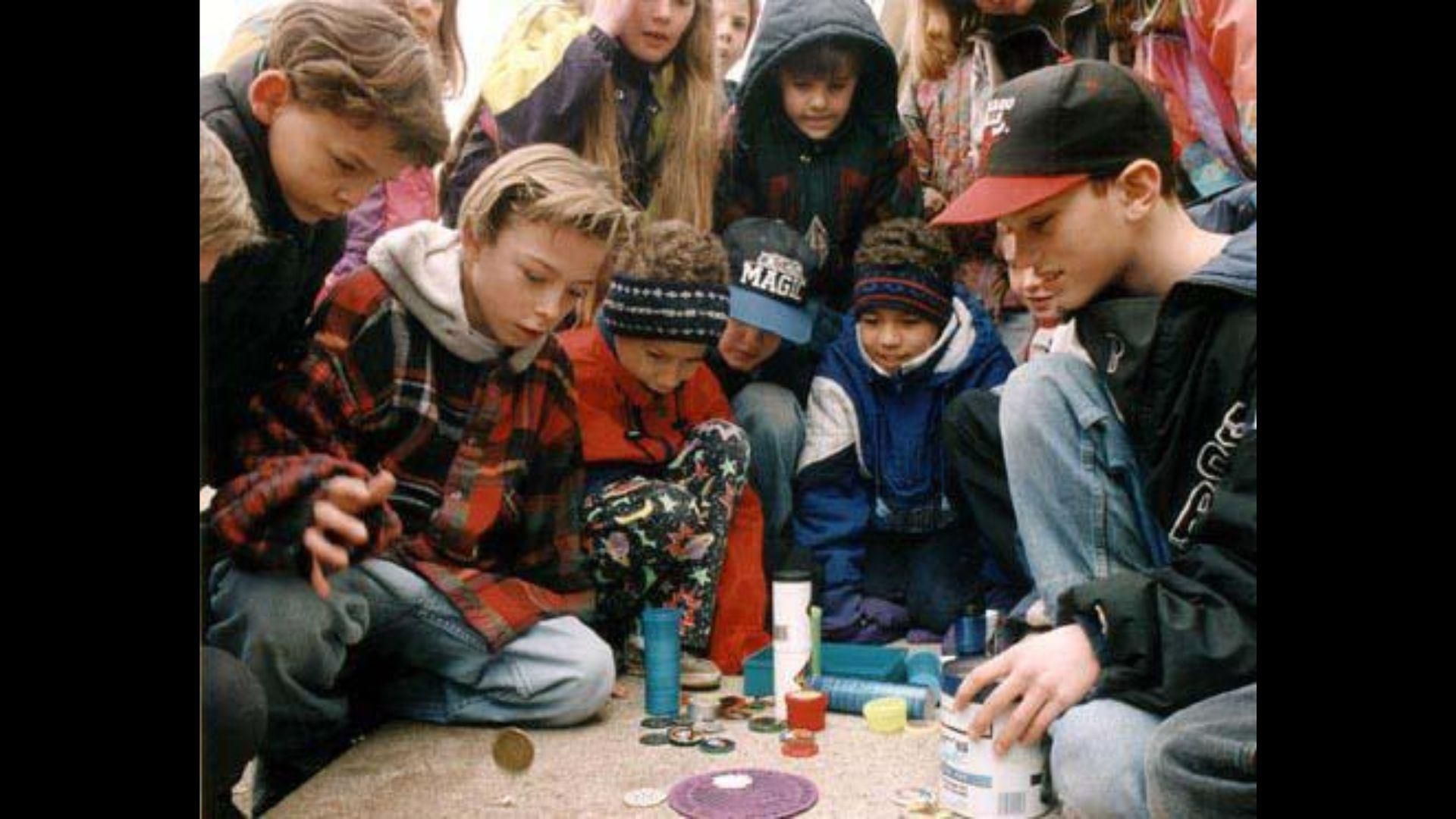 Kids in the 90s playing with toys on the street
