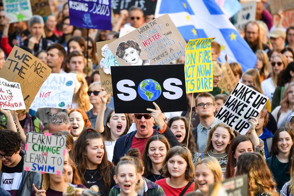 Protesters march and hold placards as they attend the Global Climate Strike in Scotland