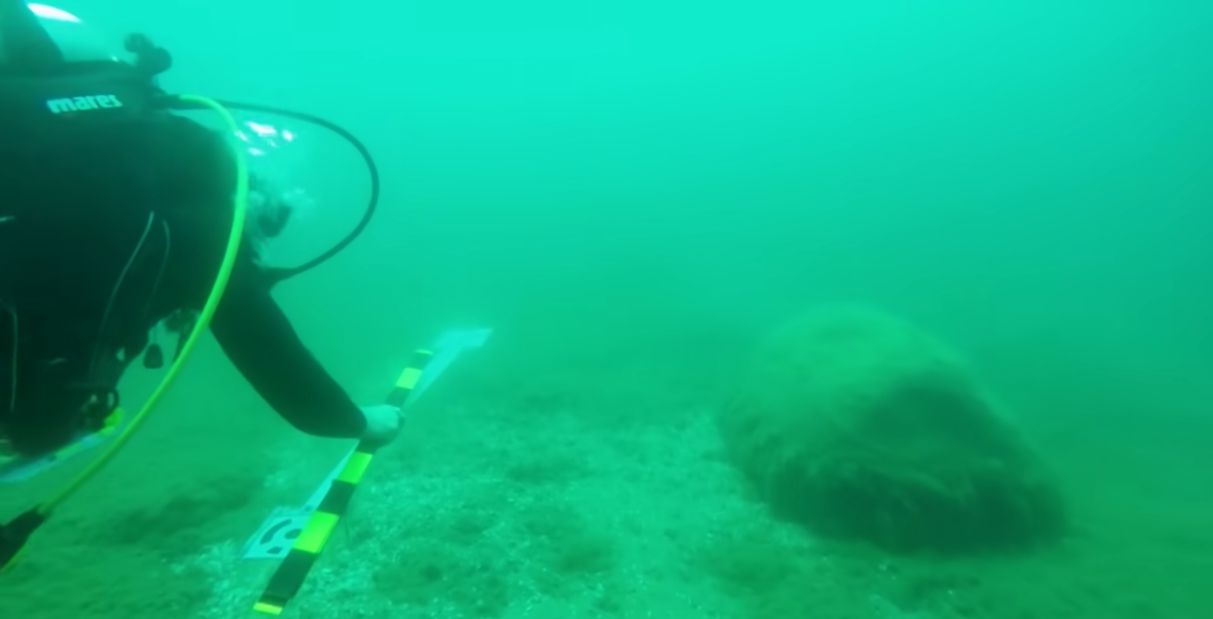 Scientist Rob Nelson measures the rocks in formation at the bottom of Lake Michigan