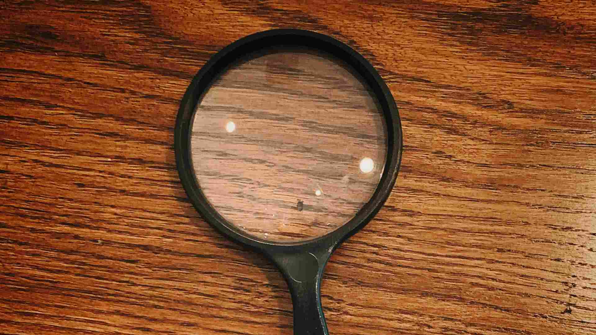 A magnifying glass sitting on a table.