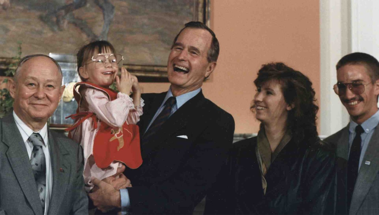 Baby Jessica held by the President of the United States.