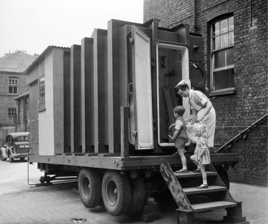 A nurse and two young patients enter a pressure chamber at Park Hospital, Hither Green, London, as a series of experiments was carried out to combat whooping cough by reducing air pressure, 1949