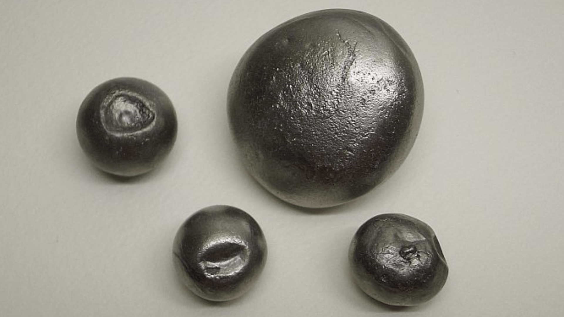 Nuggets of beryllium sitting against a white background.