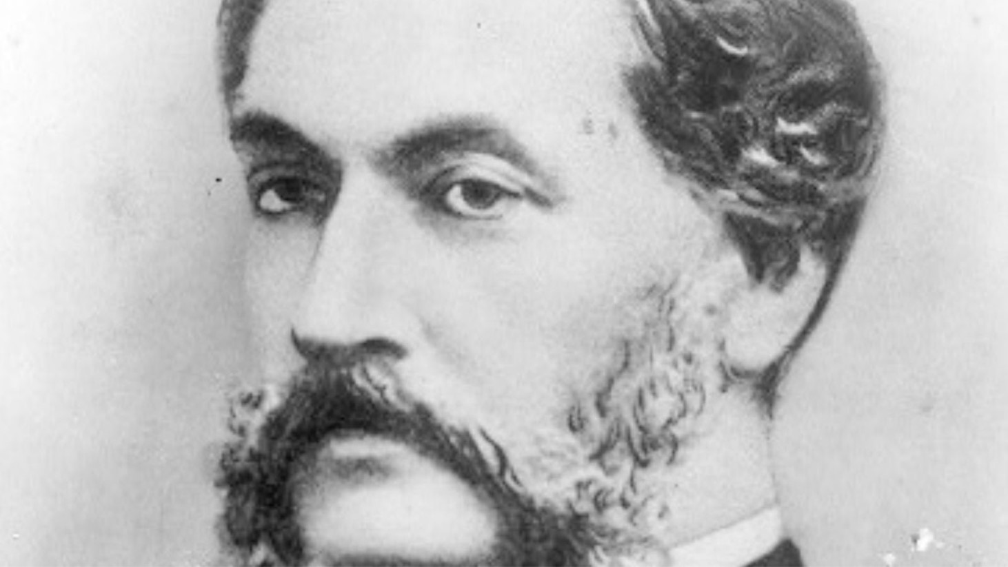 Close-up black and white photograph of Louis Le Prince with dark, parted hair and a full beard, styled into a distinct sideburn-mustache combination