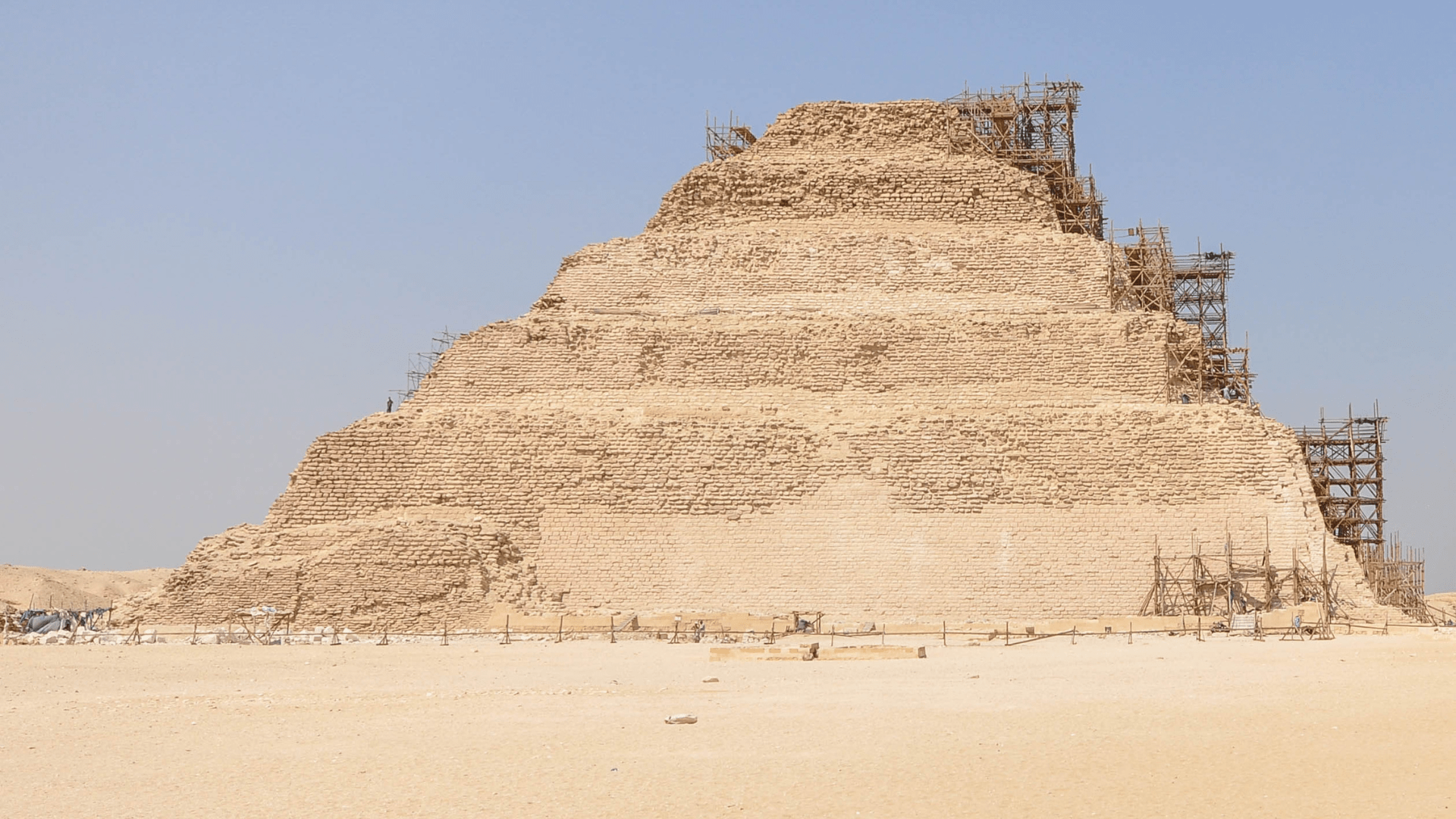 The step-pyramid named The Pyramid of Djoser (or Zoser) shown in 2012 with scaffolding along the right side during restoration efforts.