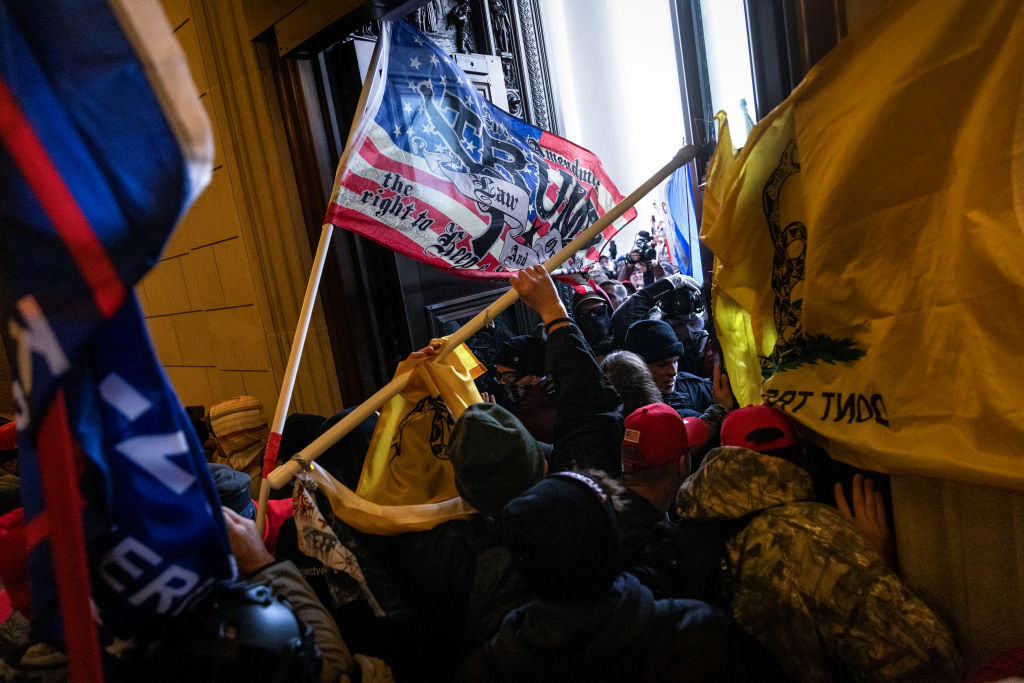 A pro-Trump mob breaks into the U.S. Capitol on January 6, 2021 in Washington, DC. Congress held a joint session today to ratify President-elect Joe Biden's 306-232 Electoral College win over President Donald Trump. A group of Republican senators said they would reject the Electoral College votes of several states unless Congress appointed a commission to audit the election results.