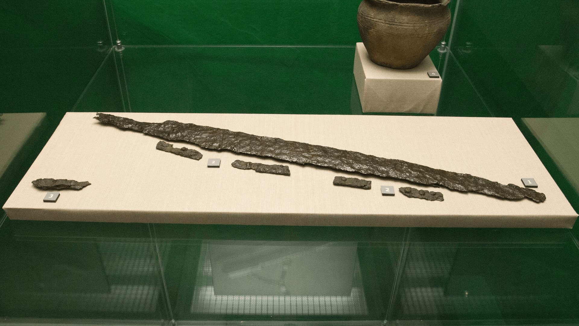 An Avar sword on display under glass in a museum.