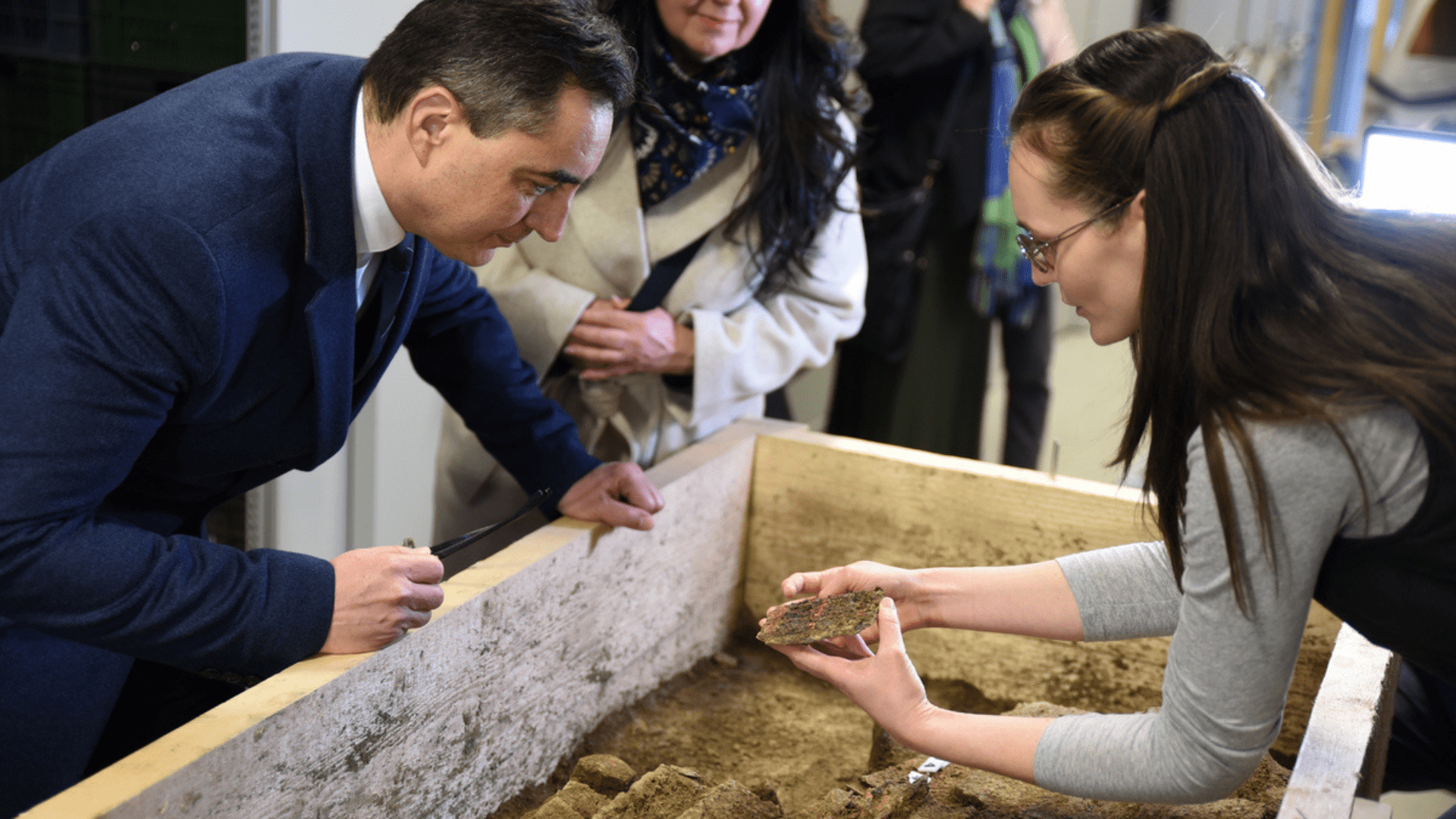Archaeologists at Déri Museum observing pieces from the Ebes excavation.