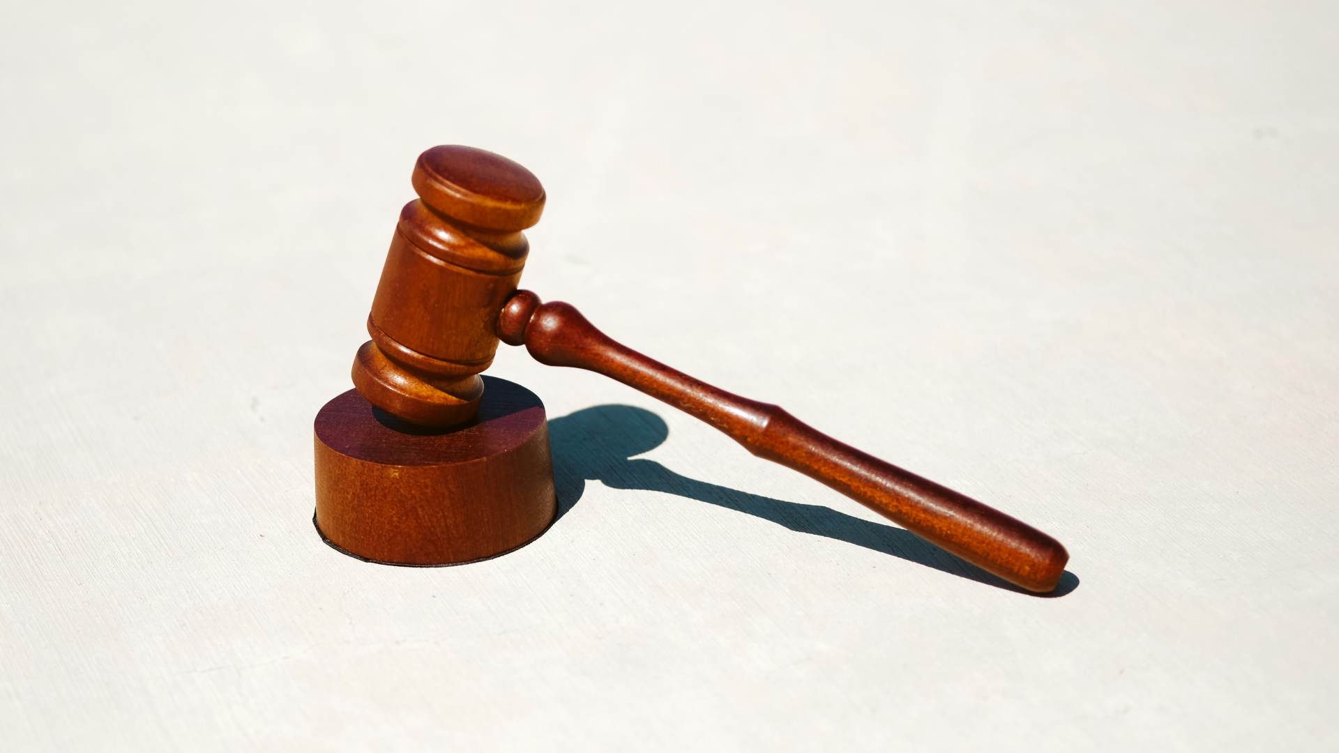 A gavel sitting on a block that a judge would use.