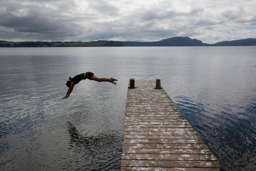 A student of Te Wharekura o Ngati Rongomai dives into the water in Rotorua, New Zealand
