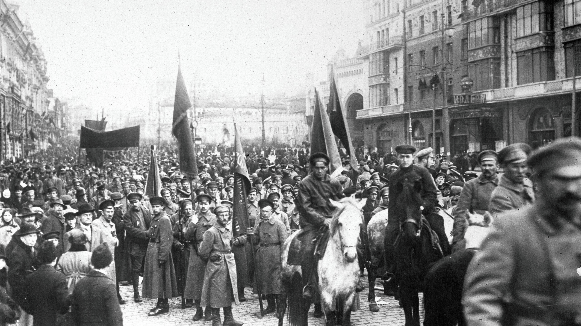 Black-and-white photo of Bolshevikes parading through the streets of Moscow during the October Revolution of 1917.