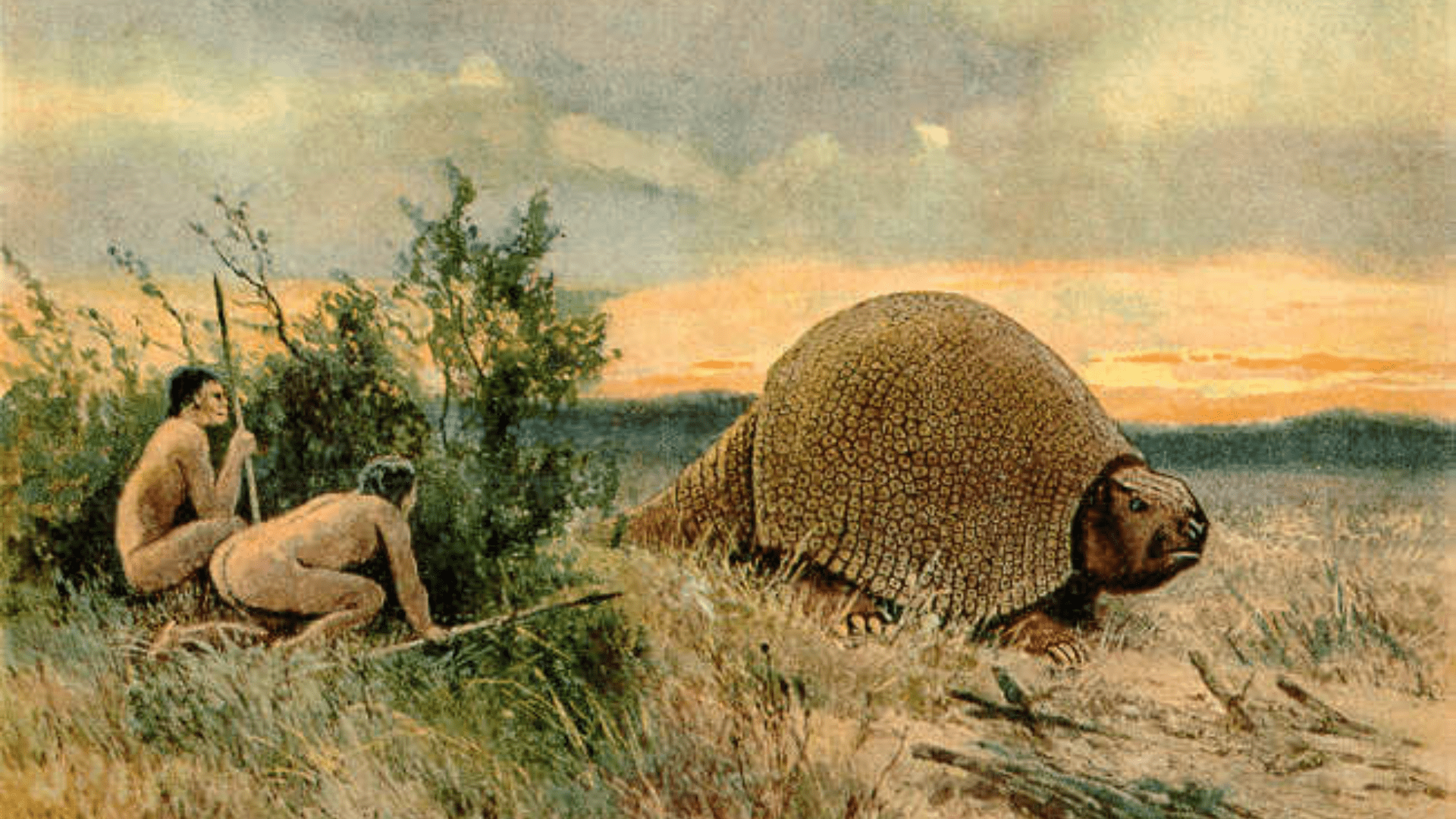 Two early humans hiding behind a bush with spears watching what is possibly a glyptodont, or extinct, large armadillo, pass by.