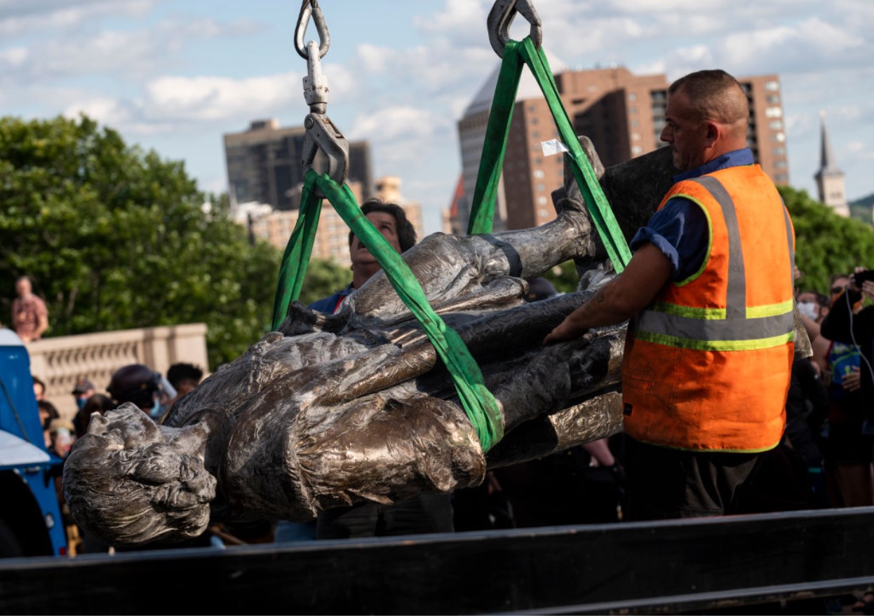 A statue of Christopher Columbus, which was toppled by protesters, is loaded onto a truck on the grounds of the State Capitol in Minnesota