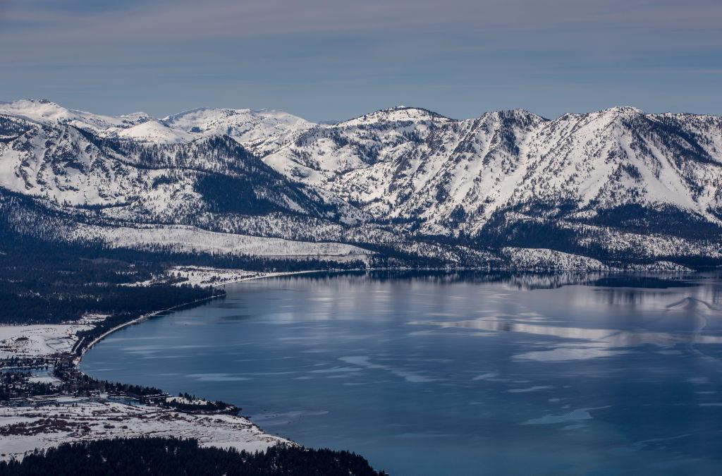 The lake and snow-covered mountains are viewed from the Heavenly Ski Resort observation deck