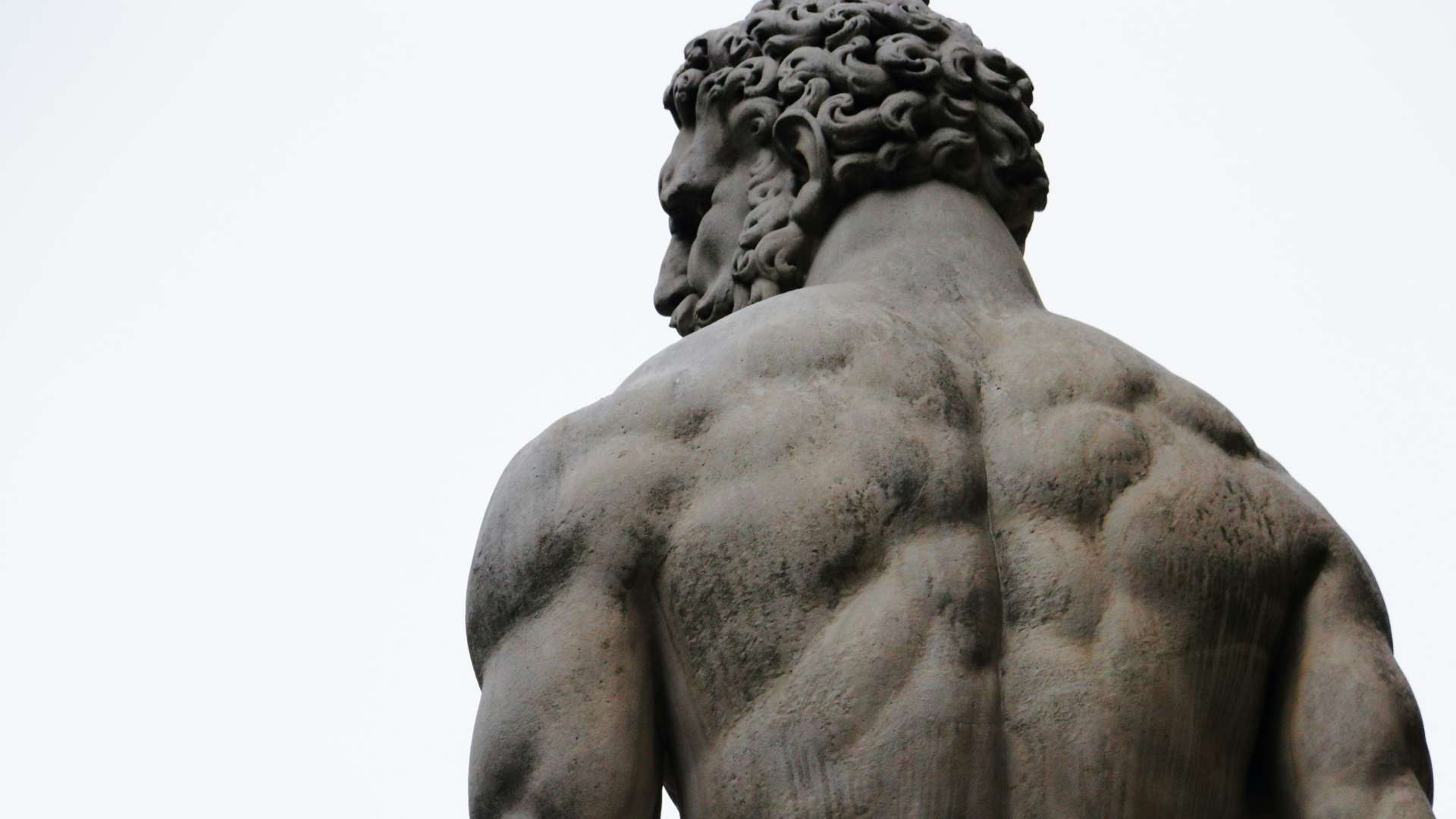 A statue of Hercules facing away from the camera.