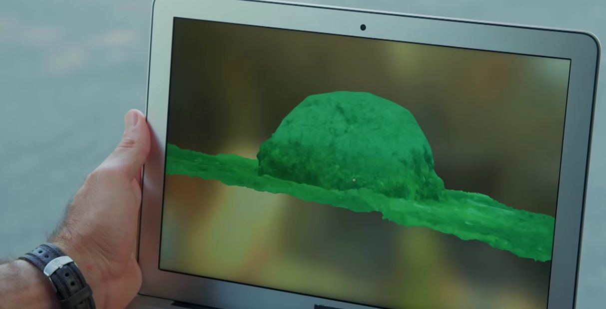 Screenshot of a YouTube video by @DiscoveryUK laptop showing photos of the underwater rock formation in Lake Michigan