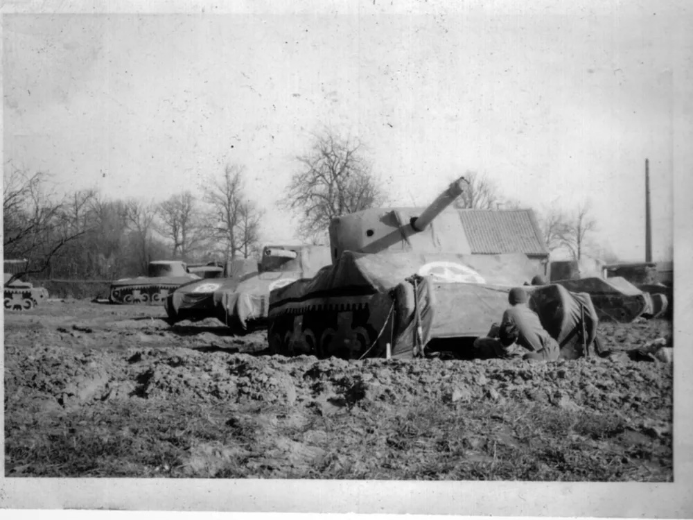 A gray-scale image of an inflatable tank in a field