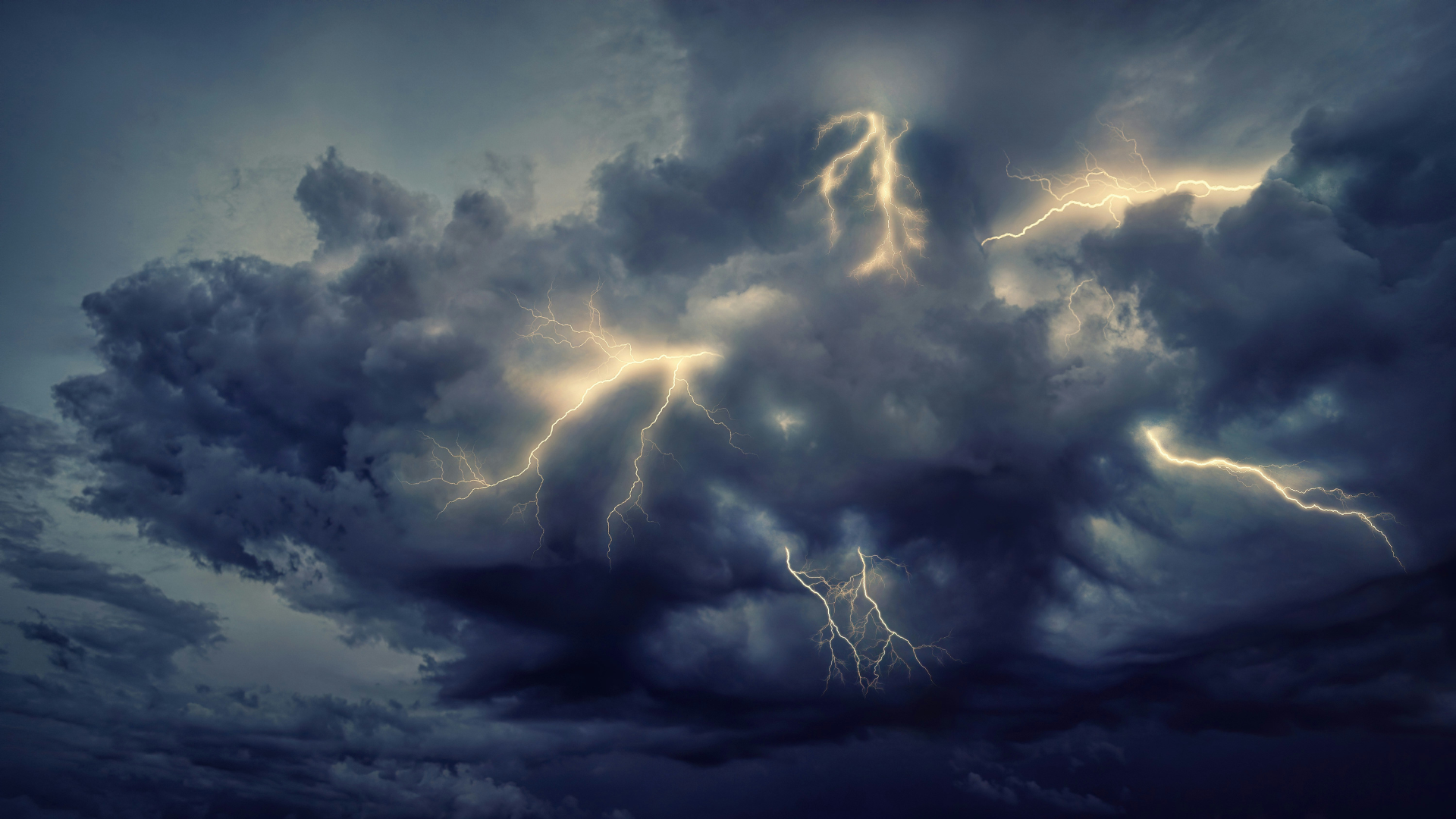 A lightning storm rages in the dark, cloudy sky. bolts of lightning rain down in various directions.