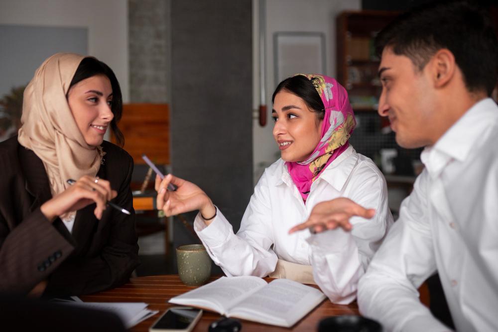 A committee meeting is held in an office in Egypt between three co-workers