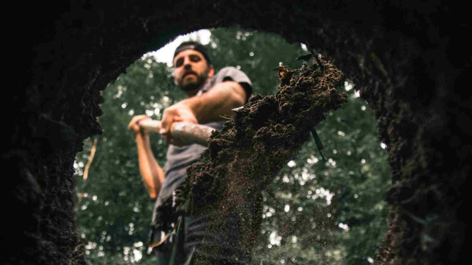 A man filling a hole with dirt.