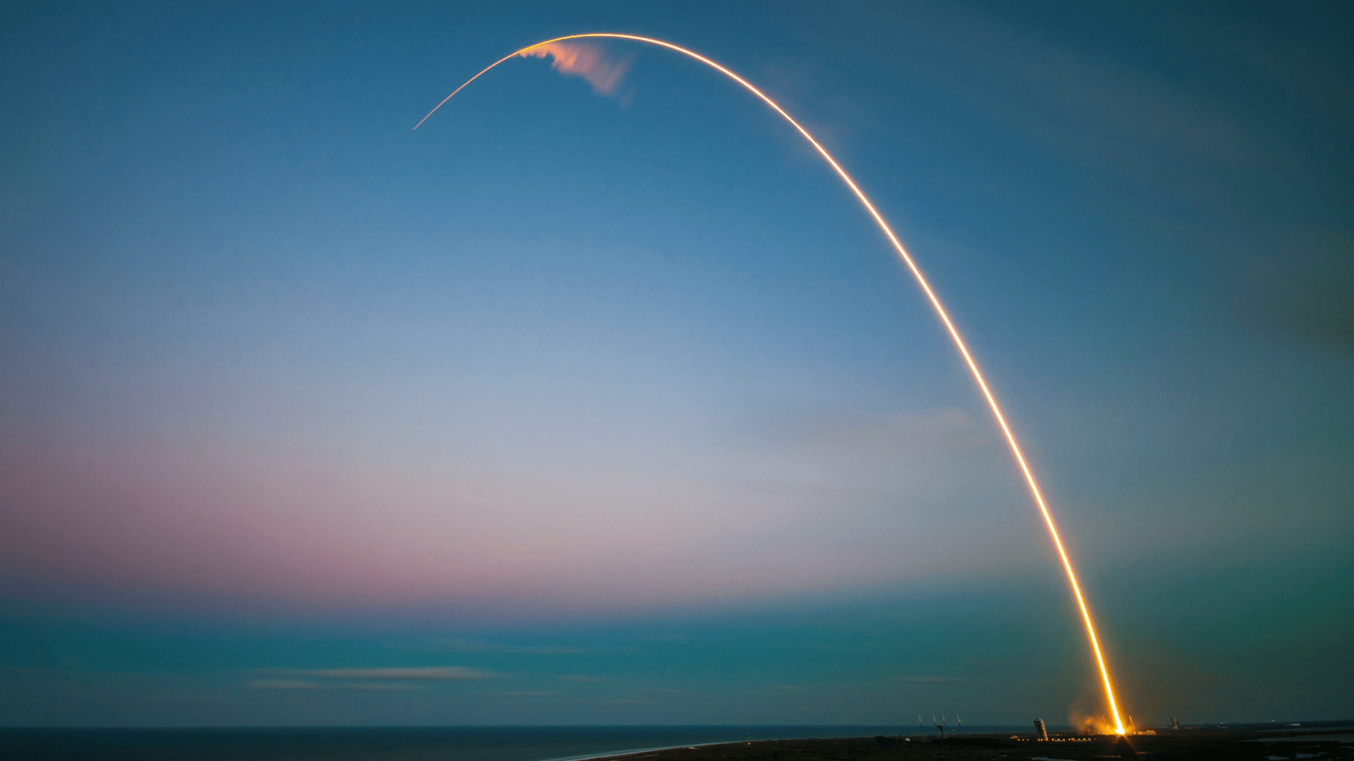 A SpaceX rocket leaves behind an arch of light after launching from Cape Canaveral.
