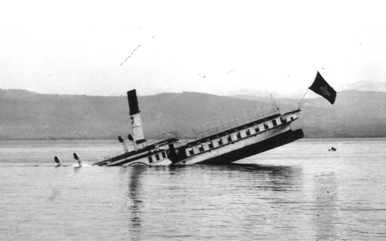 Photograph of the Saentis steamship, known as the “Titanic of the Alps” sinking on Lake Constance in 1933