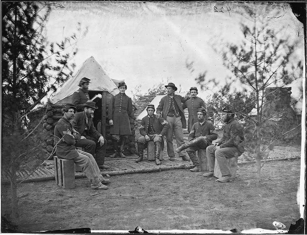 A grayscale image of a group of soldiers in camp during the Civil War