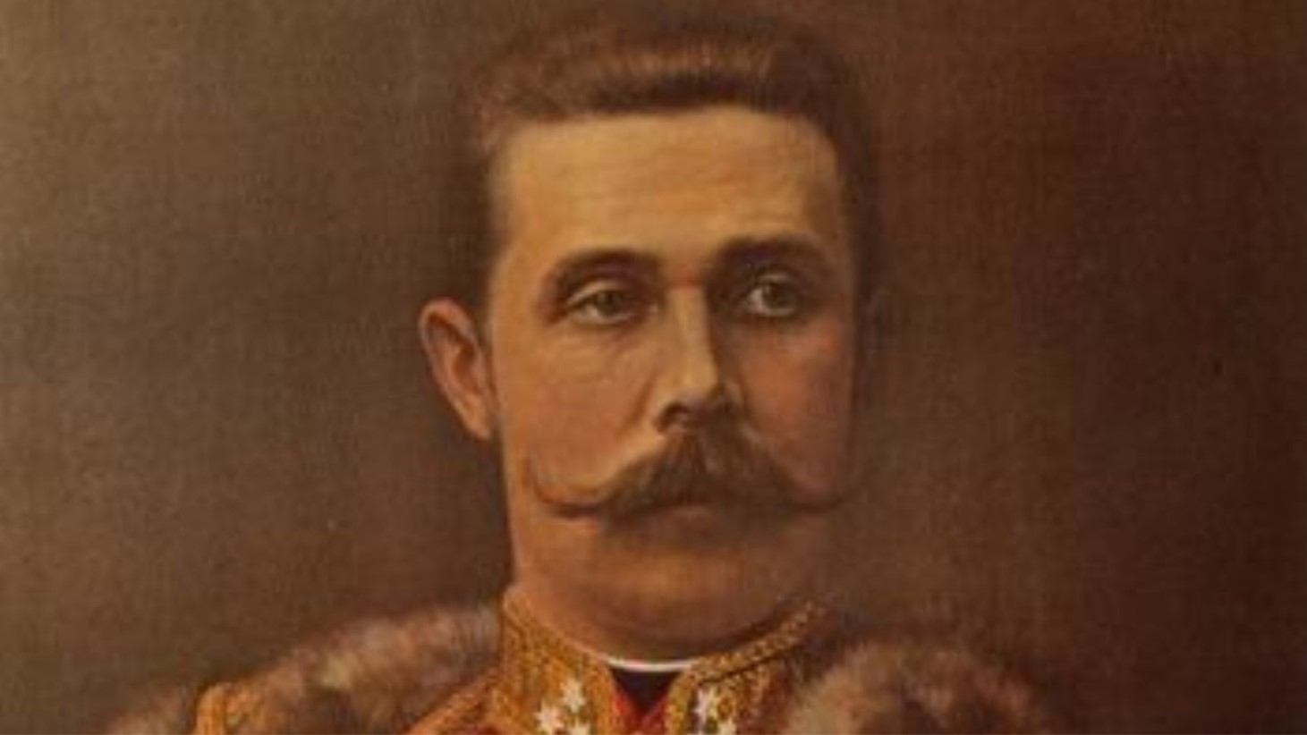 A close-up portrait of Archduke Franz Ferdinand, depicted in a warm-toned painting. He has a neatly trimmed mustache and is dressed in a military uniform adorned with various medals and decorations