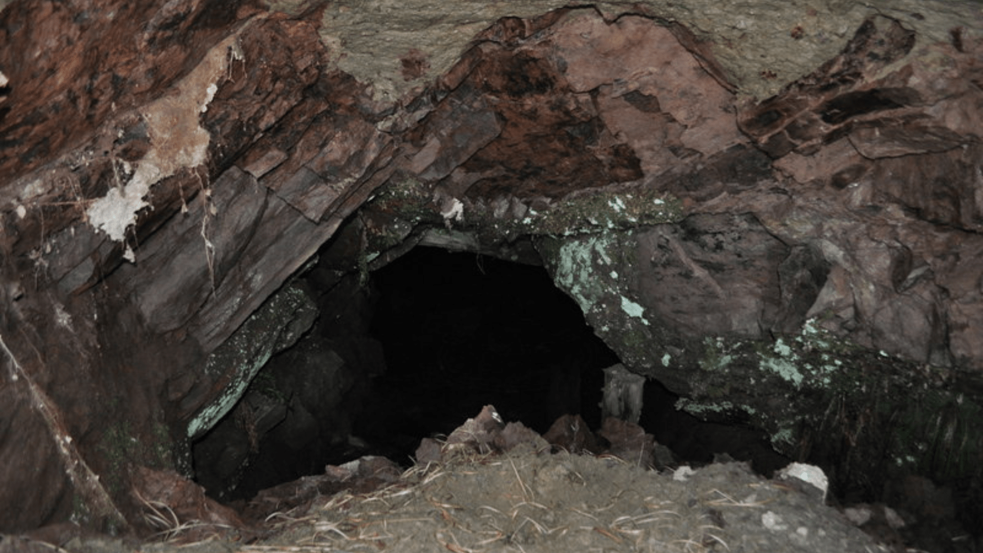 The opening of a mine shaft.