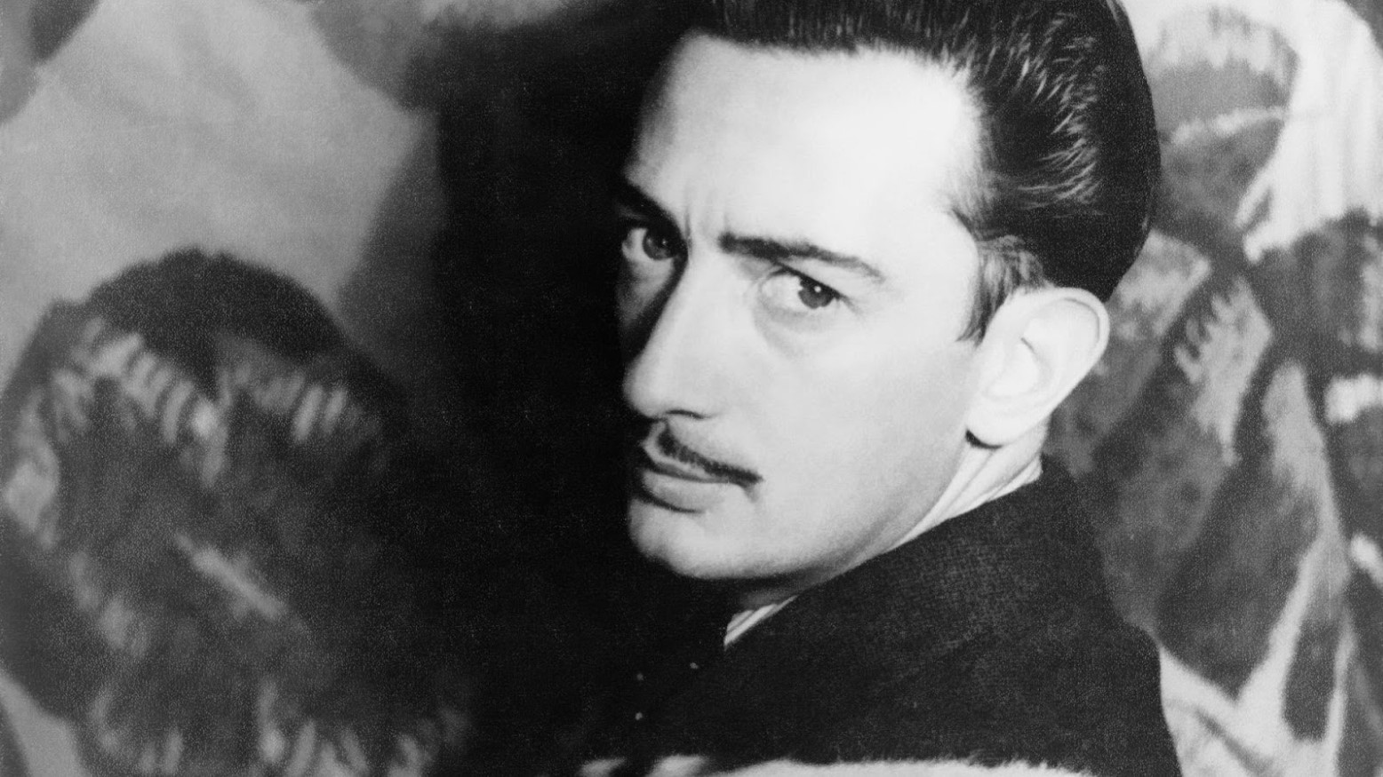 A black and white photo of Salvador Dali.