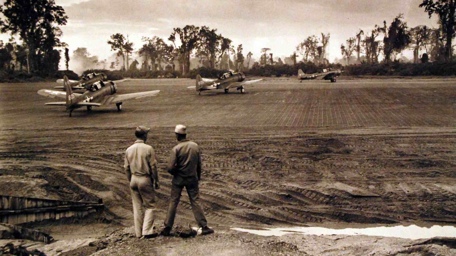 Planes from the Marine Scout Bombing Squadron 236 taking off in the early morning.