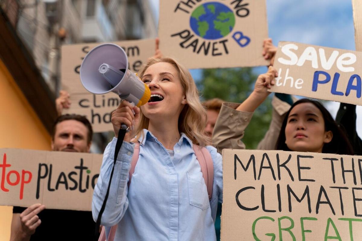 Protestors holding signs and a megaphone for climate change