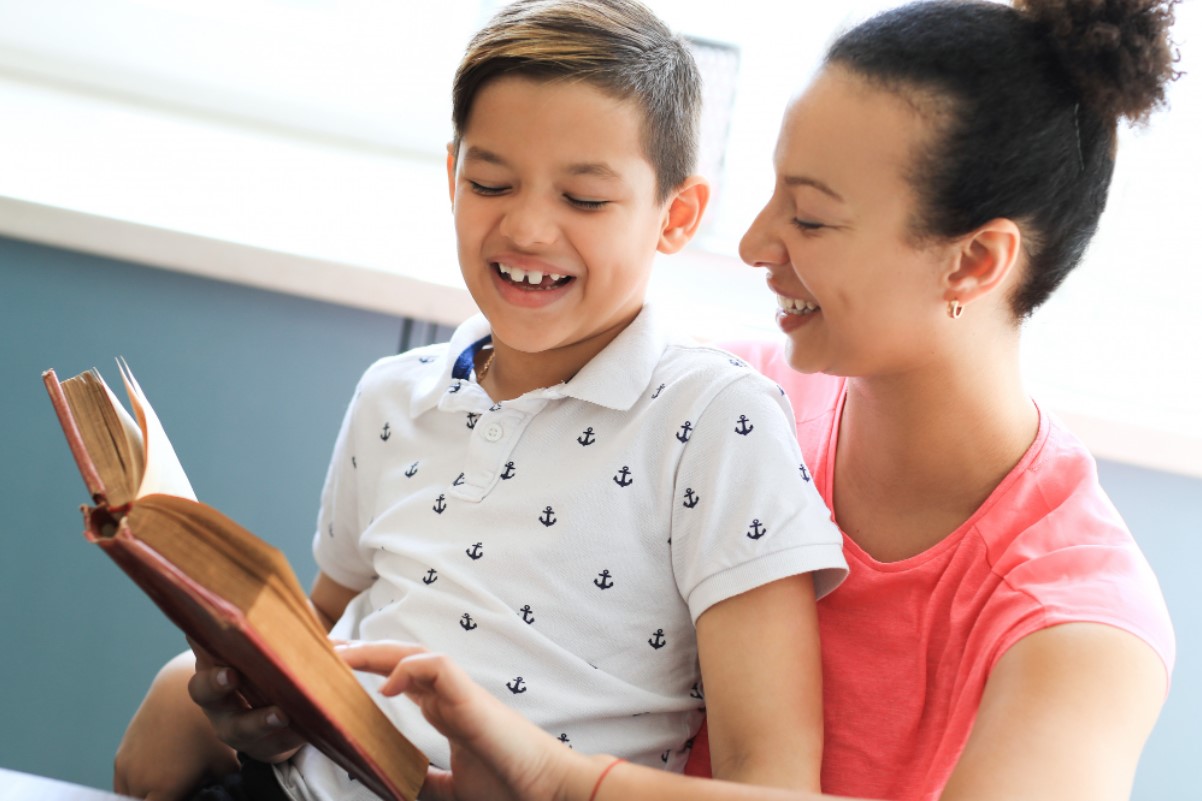 An image of a mother as she reads a story to her child