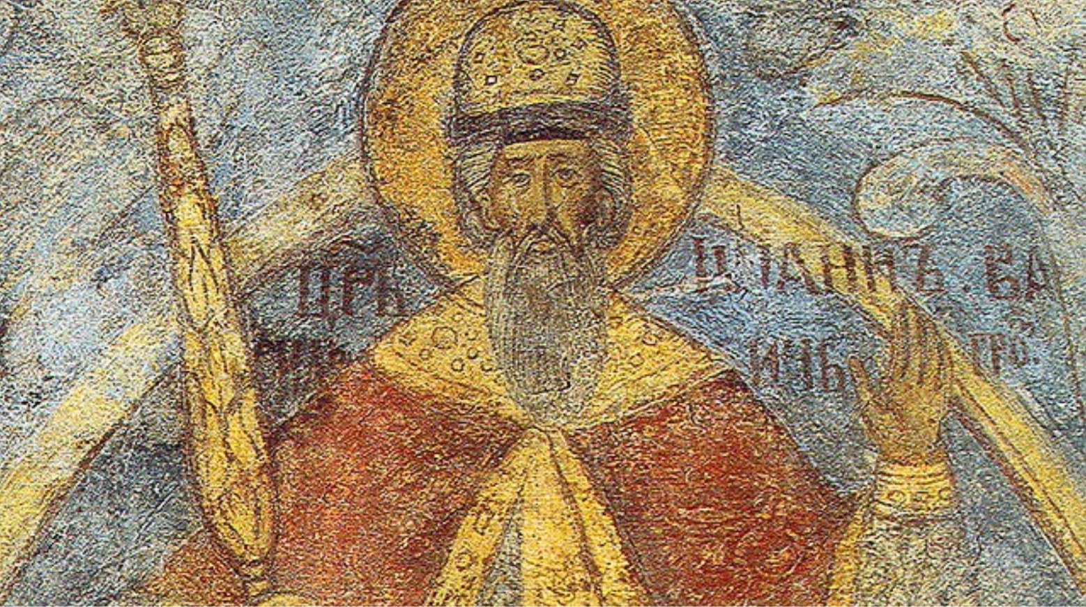 A printed painting of Ivan the Terrible. He has a gold crown, a red and gold robe, and is holding a golden sceptre. The background of the painting is blue.