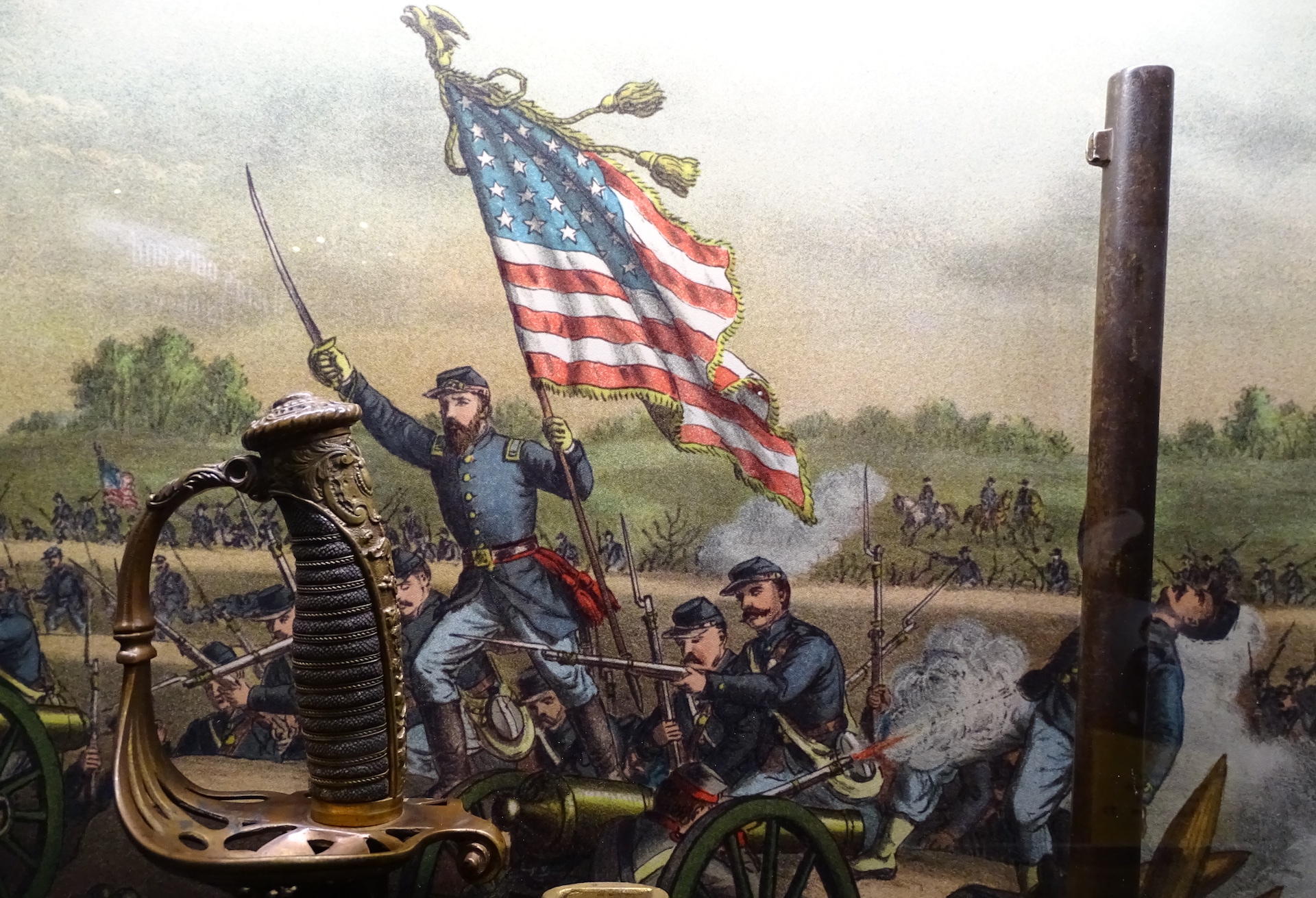 A U.S. Union solider holding an American flag and a sword