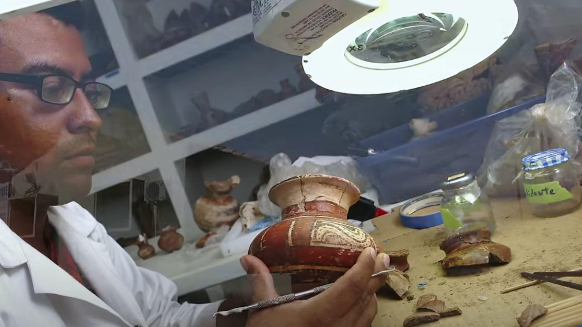Archaeologist examines a piece of pottery found in tomb No. 9 at the El Caño archaeological site in Panama