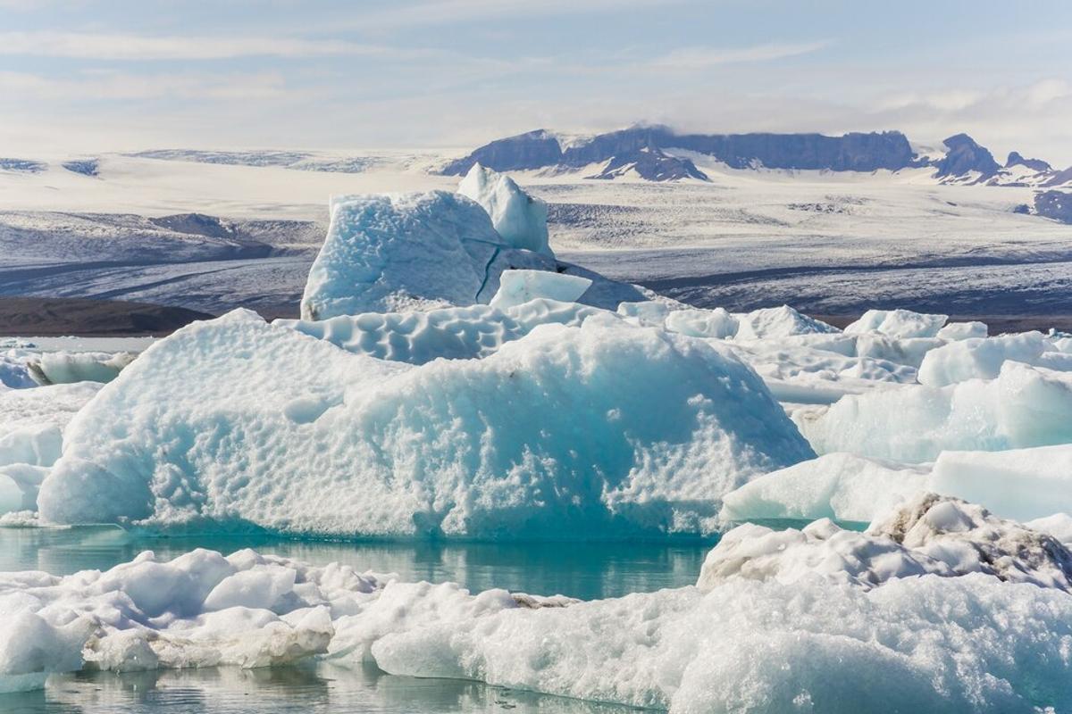Icebergs in the northern oceans with snowy mountains in the background