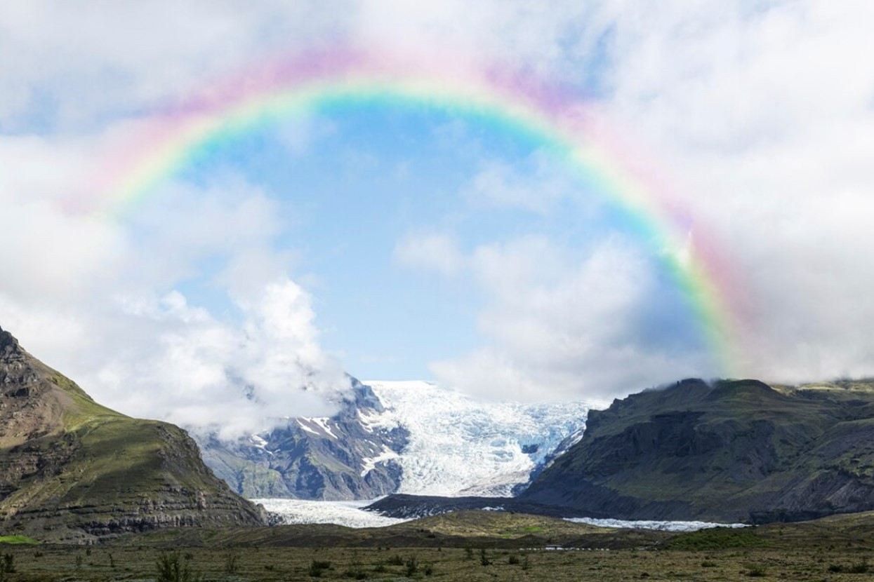 Rainbow over a snowy mountain