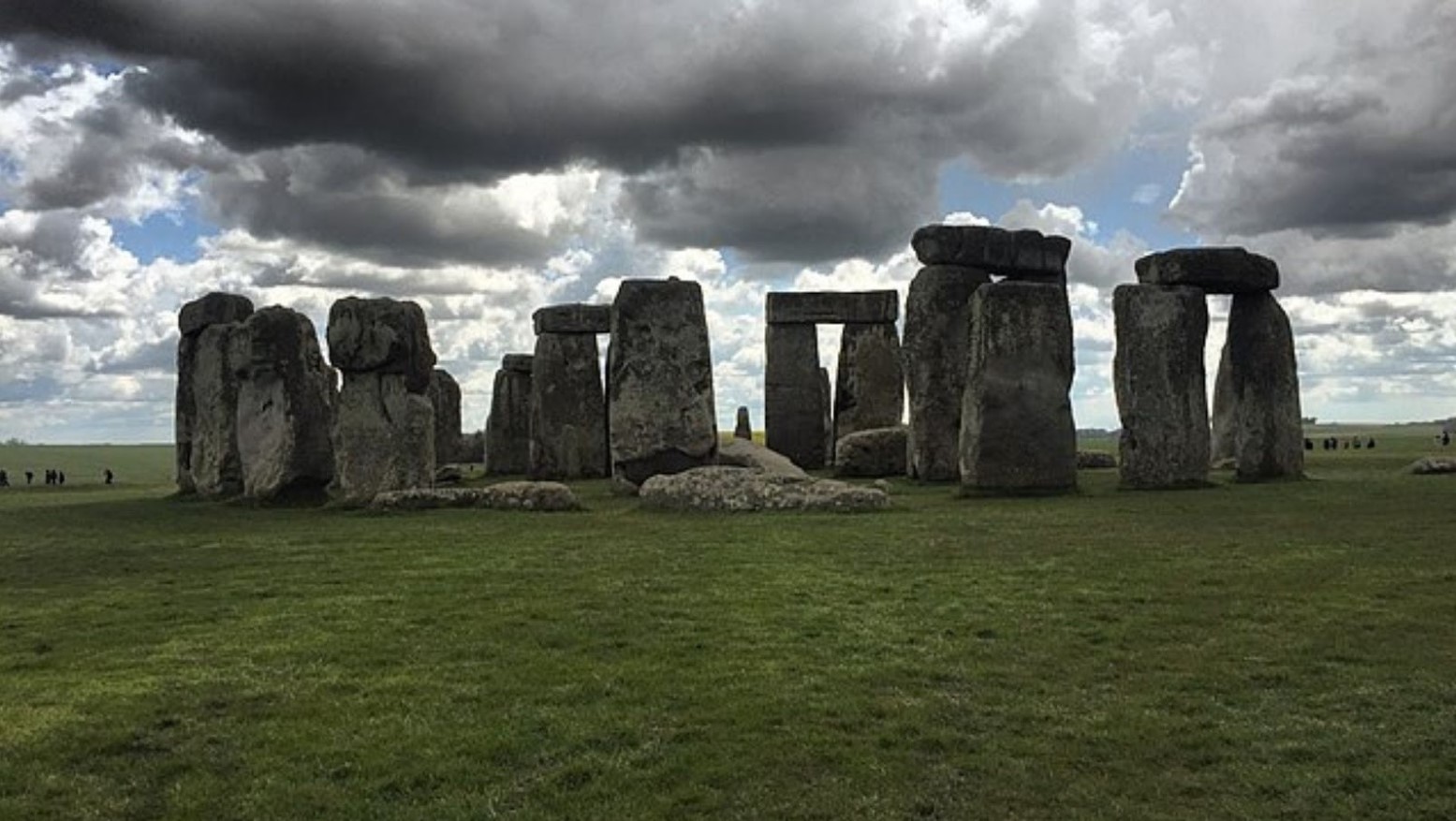 An image of Stonehenge from a distance on a cloudy day.