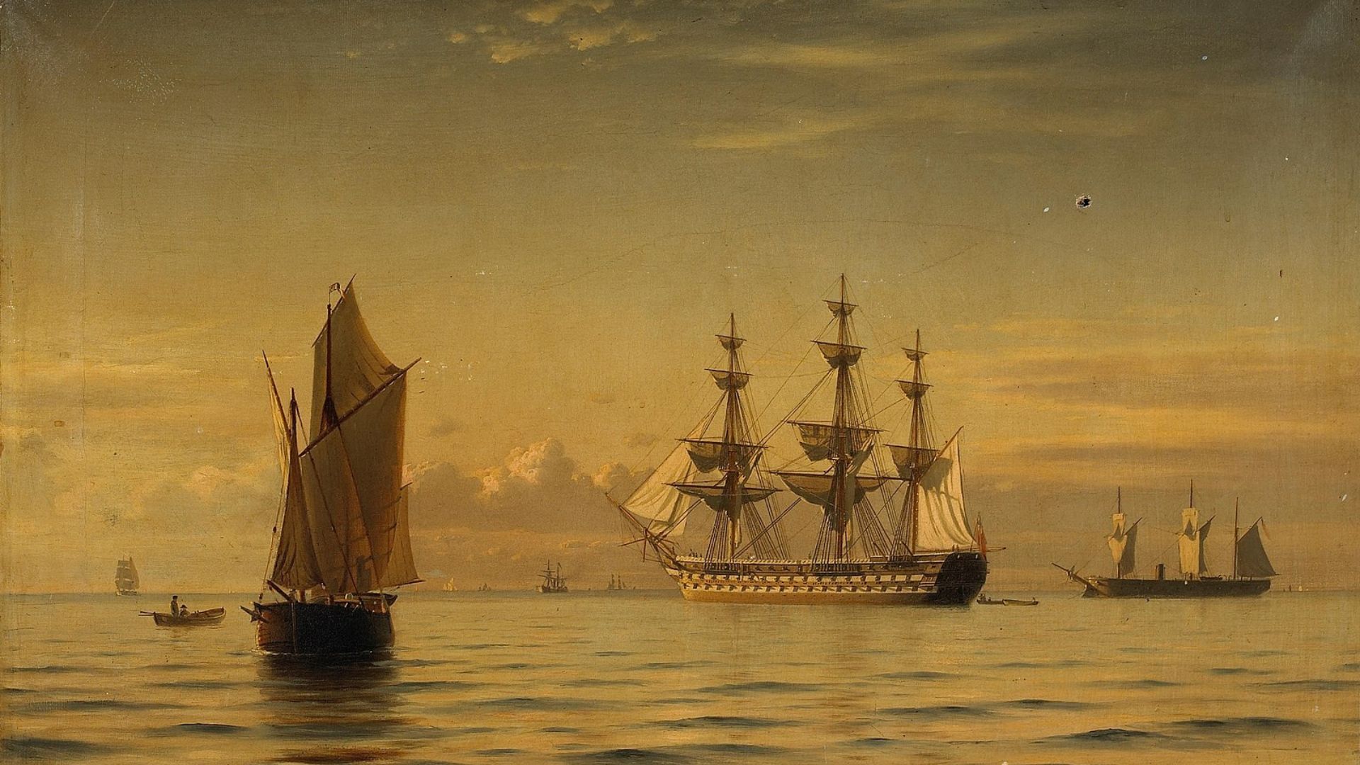 An oil painting depicting a tranquil sea scene at sunset. The golden light of the setting sun reflects off the calm waters. In the foreground, a small boat with two large sails is anchored, with a rowboat beside it. Dominating the center is a large, multi-masted ship of the line, its sails unfurled and still