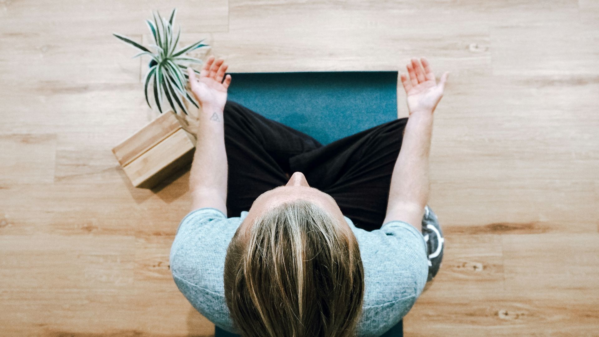 A woman on a yoga mat meditating.
